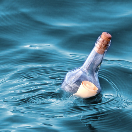 message in a bottle floating on water